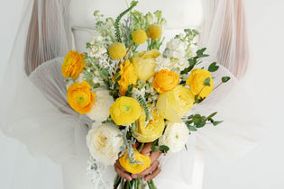 yellow bridal bouquet being held by bride