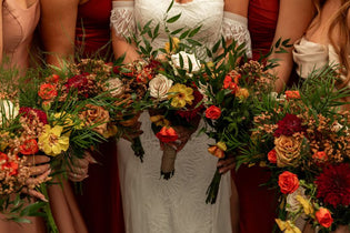 bride with bridesmaids holding their bridal bouquets
