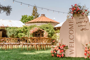 welcome sign with three flower arrangements on it