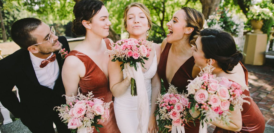bridal party together with the wedding flower bouquets