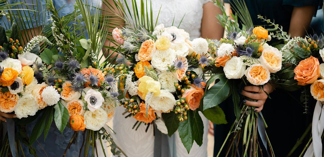 orange, white, yellow, and blue bridal and bridesmaids bouquets