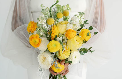 yellow bridal bouquet being held by bride