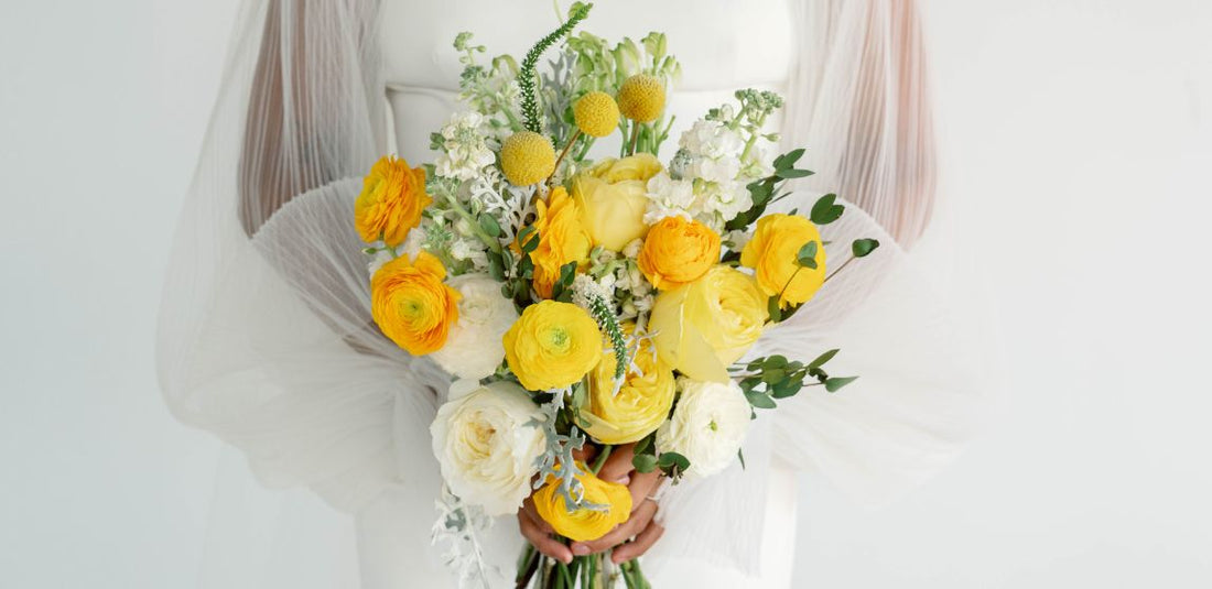 yellow bridal bouquet being held by bride