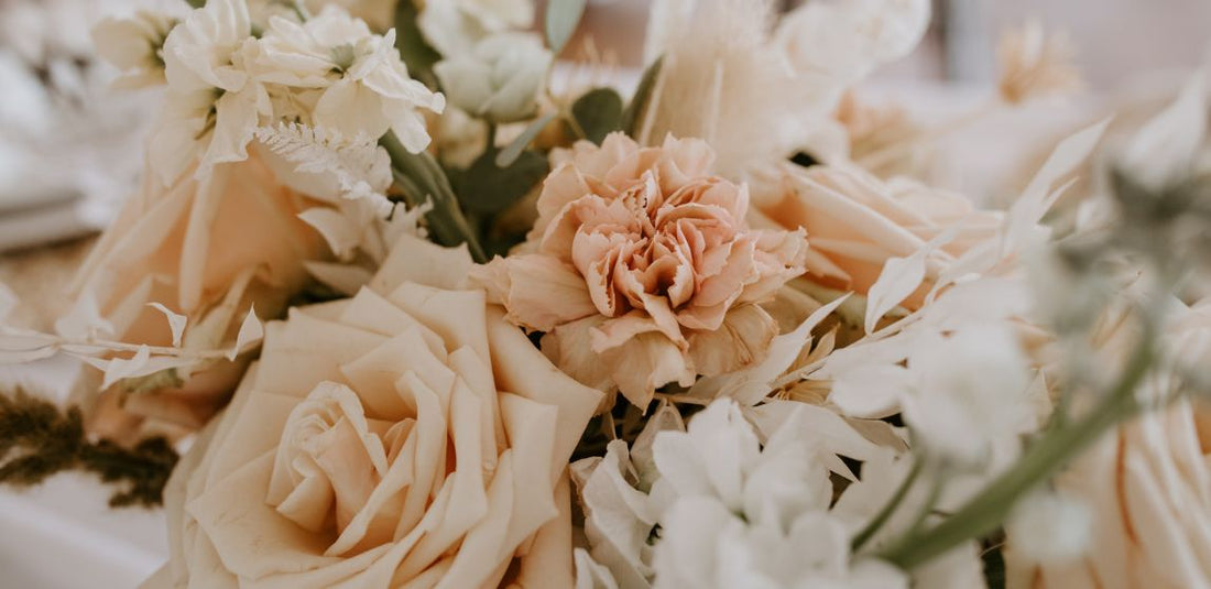 blush, tan, and white carnations and roses up close in a budget bouquet