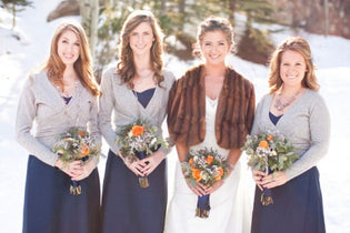 bride and bridesmaids holding winter wedding bouquets