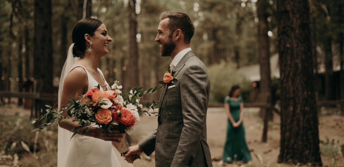 bride and groom looking at each other in their modern California boho wedding
