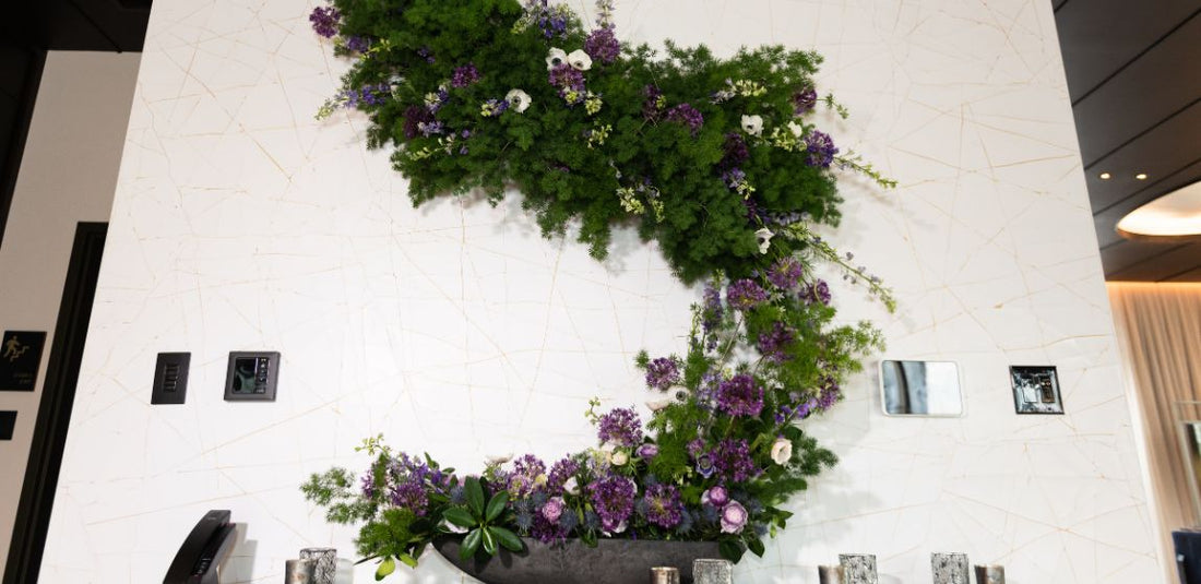 purple flowers with greenery arrangement flower wall
