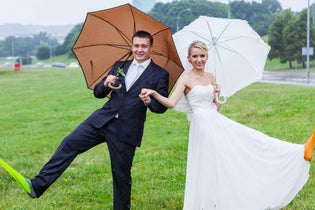 bride and groom under umbrellas with scuba flippers on their feet