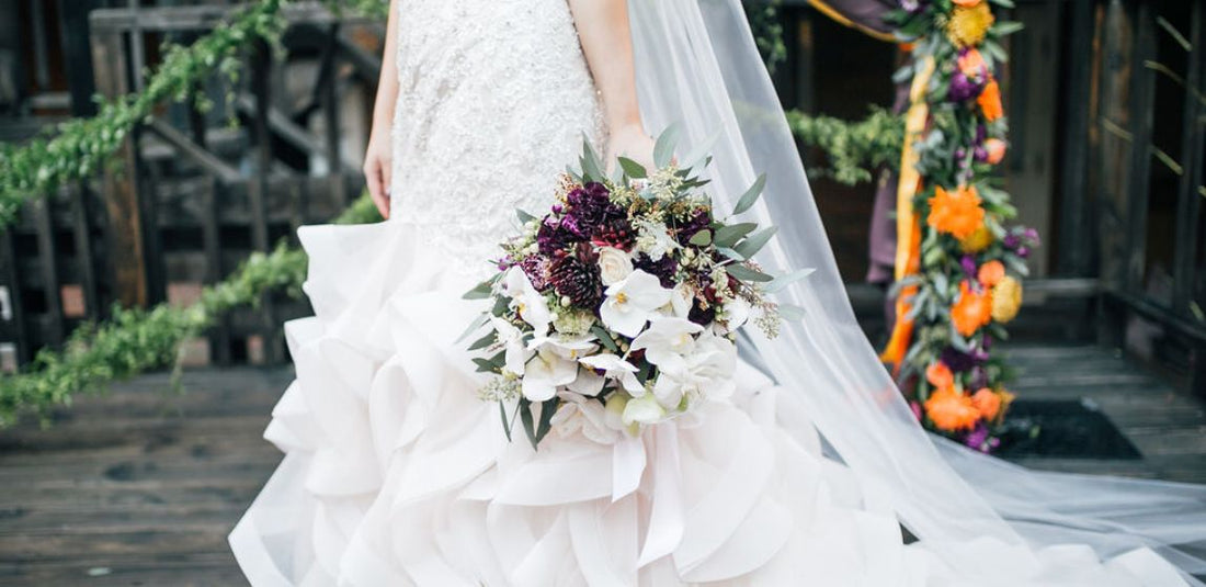 bride holding a sustainably made bridal bouquet