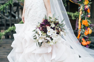 bride holding a sustainably made bridal bouquet
