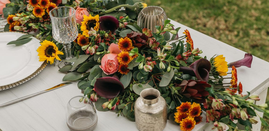 table centerpiece with garland and other fresh flowers