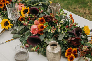 table centerpiece with garland and other fresh flowers