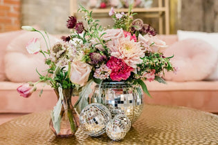 groovy wedding photo that features a disco ball vase with pink and hot pink flowers