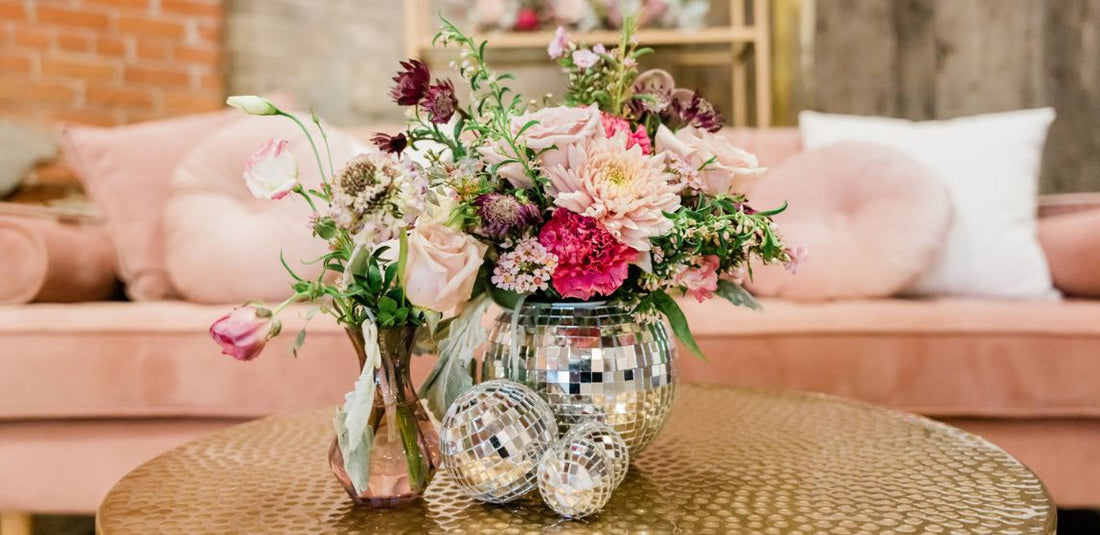 groovy wedding photo that features a disco ball vase with pink and hot pink flowers