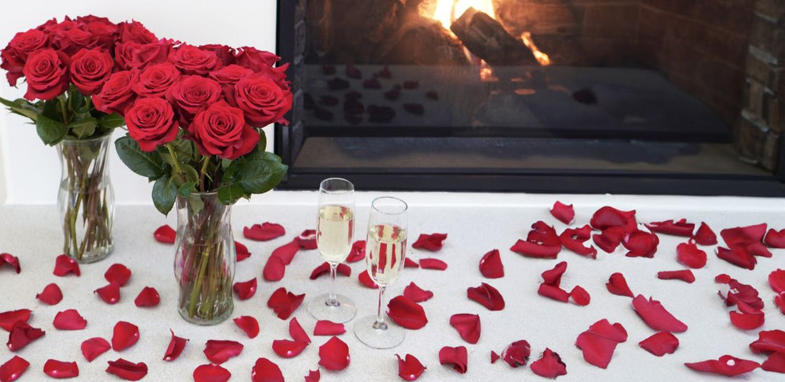 red rose bouquets and red rose petals in front of a fire place