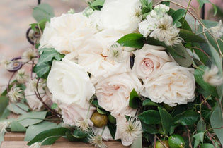 bridal bouquet with white roses, garden roses, and greenery
