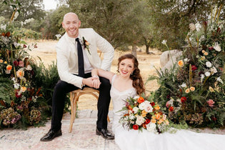 bride and groom sitting at the alter surrounded by flowers