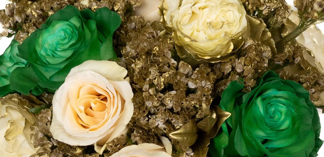 green roses, ivory roses, and golden flowers in a bouquet up close