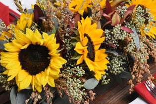 yellow sunflower arrangement with greenery