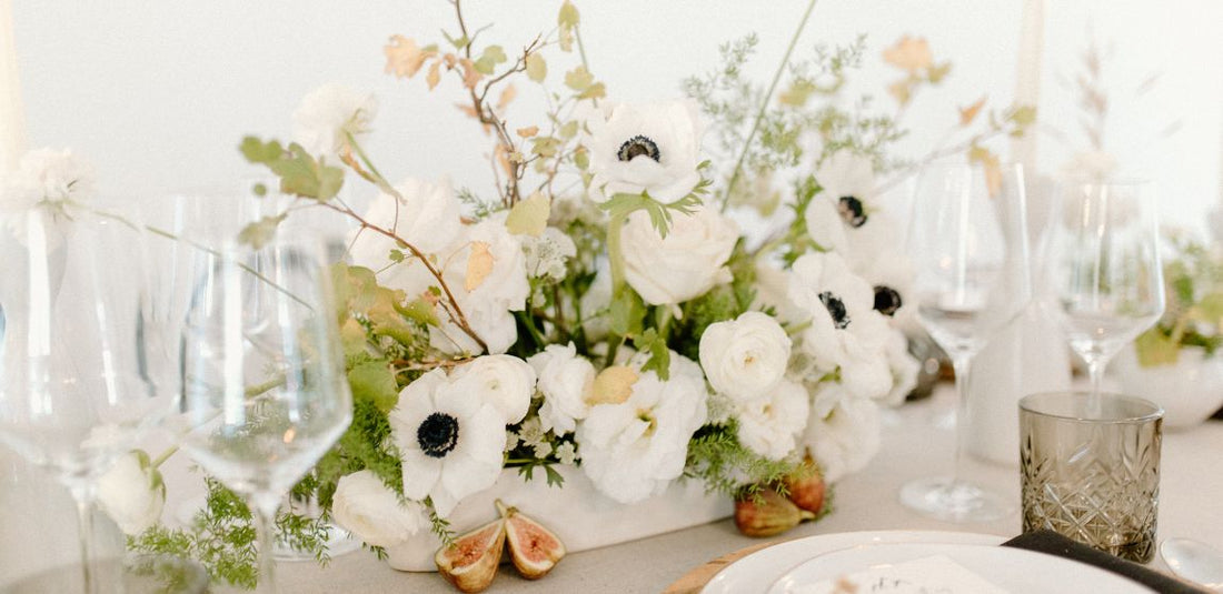 white flower table centerpiece with anemones and roses