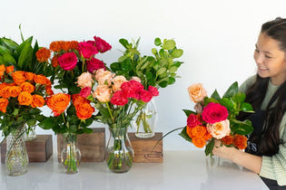 Hot pink and orange bouquet bar with brunette girl arranging a bouquet