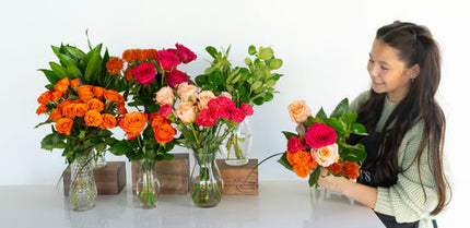 Hot pink and orange bouquet bar with brunette girl arranging a bouquet