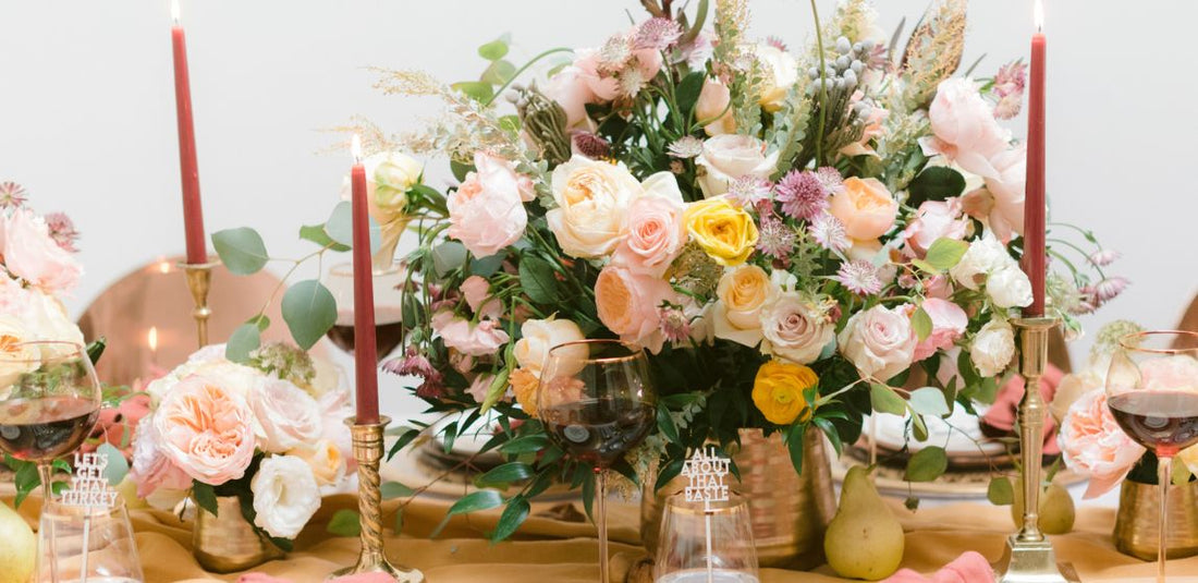 Table flower centerpiece that is pink, peach, and other pastel colors