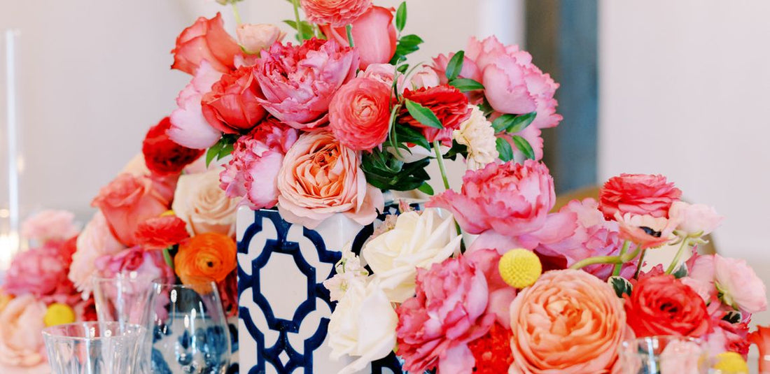 flower centerpieces with pink and hot pink flowers in blue vases