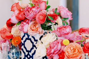 flower centerpieces with pink and hot pink flowers in blue vases