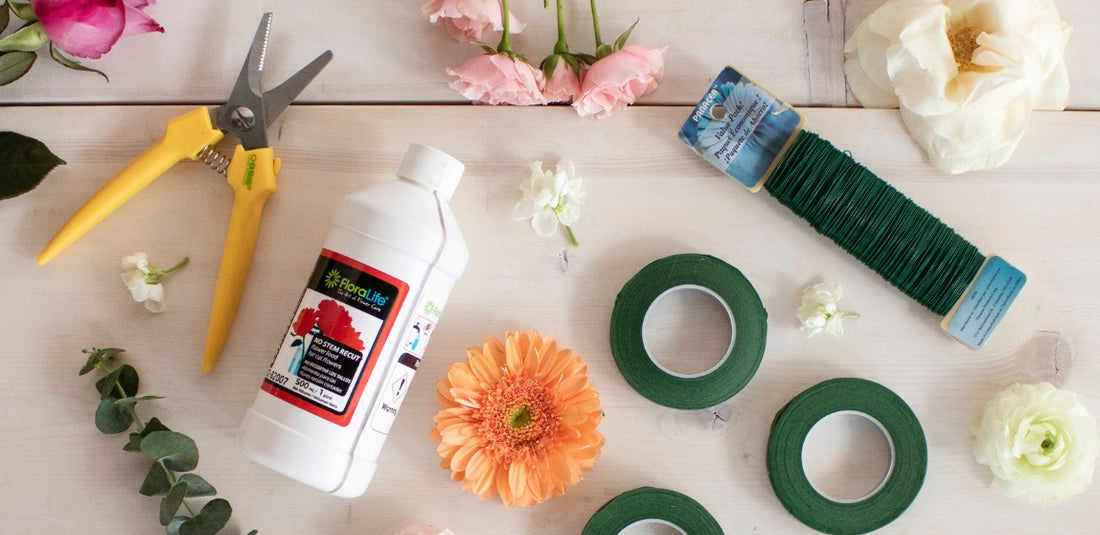 Floral shears, wire, and tape on a table around flowers