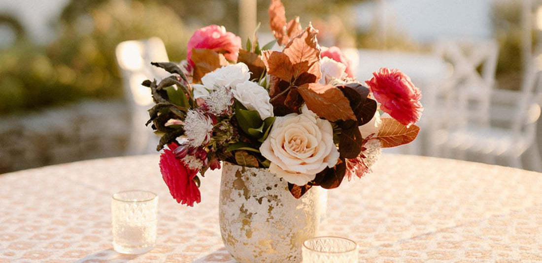 Flower centerpiece with pink, green, and brown flowers for a wedding