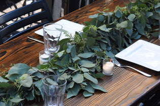 Eucalyptus Garland on a table with white plates and silverware