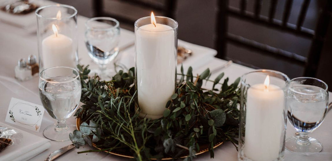 greenery centerpiece paired with three tall white candles