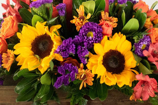yellow flowers and purple flowers in a fall arrangement