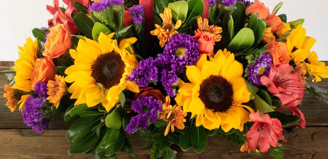 yellow flowers and purple flowers in a fall arrangement