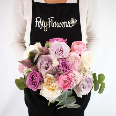 Pink and Purple Flower Centerpiece in Hand