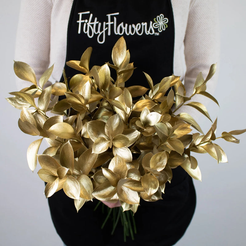 Gold Tinted Ruscus Greenery Bunch in Hand