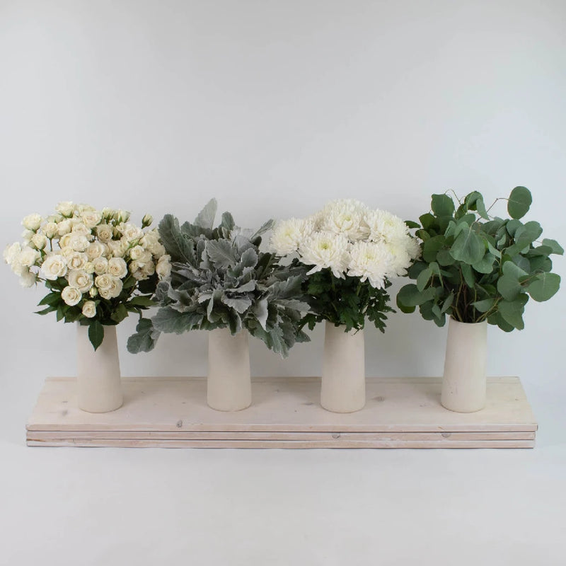 winter white artificial flowers arrangement in glass vase. Faux