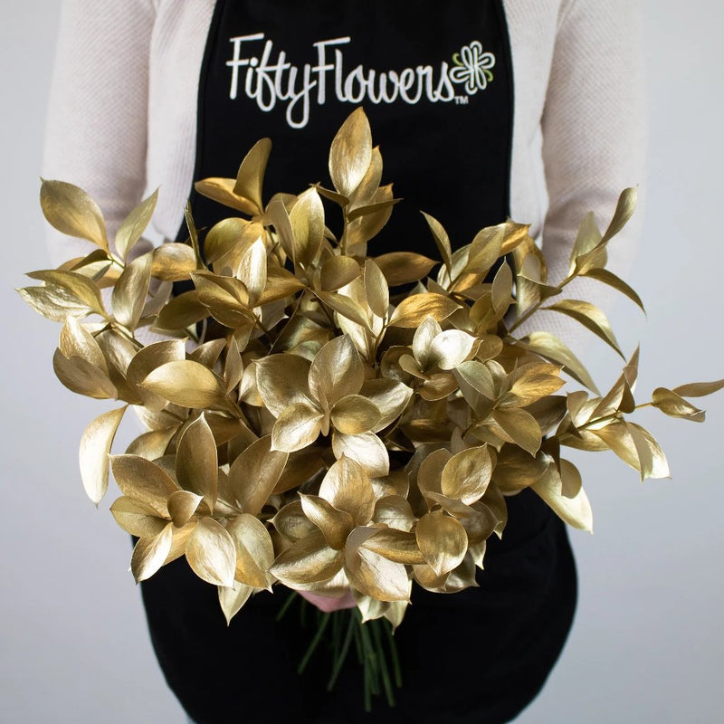 Gold Tinted Ruscus Greenery Bunch in Hand