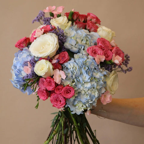 Pastel Pink and Blue Flower Bouquet in Hand